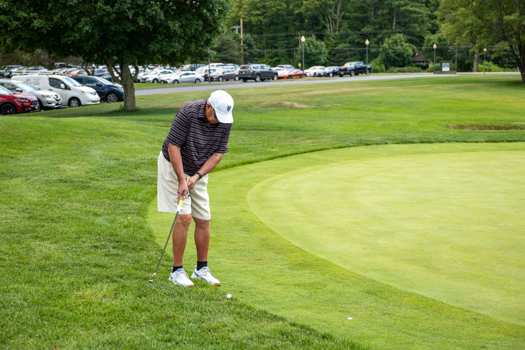 A golfer chips onto the green during the Bryan Martin Foundation scholarship scramble